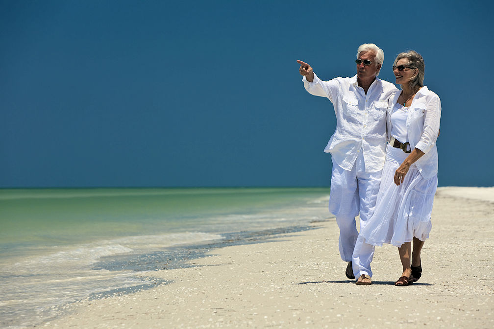 Happy senior man and woman couple leaving their group coverage.